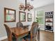 Cozy dining room with stylish lighting and a wooden table at 4284 New Broad St # 102, Orlando, FL 32814