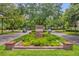 Community entrance to Baldwin Park with brick signage and lush landscaping at the street intersection at 4284 New Broad St # 102, Orlando, FL 32814
