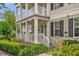 Charming two-story home featuring a welcoming front porch and manicured landscaping at 4284 New Broad St # 102, Orlando, FL 32814