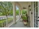 Relaxing front porch with wicker furniture, view of the street, and nice greenery at 4284 New Broad St # 102, Orlando, FL 32814