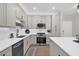 Modern kitchen featuring stainless appliances, quartz countertops, and plenty of storage at 4284 New Broad St # 102, Orlando, FL 32814