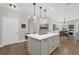 Modern kitchen featuring a large island, an open concept dining area and hardwood floors at 4284 New Broad St # 102, Orlando, FL 32814