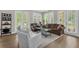 Bright and airy living room with hardwood floors and large windows at 4284 New Broad St # 102, Orlando, FL 32814