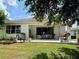 Covered patio with outdoor seating, perfect for entertaining and relaxation in a private backyard at 541 Kistler Cir, Clermont, FL 34715