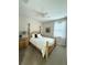 Cozy bedroom with a wood four-poster bed, floral artwork, and soft natural light at 541 Kistler Cir, Clermont, FL 34715