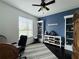 Bedroom features a blue accent wall, decorative items on shelves, and a comfortable workspace at 541 Kistler Cir, Clermont, FL 34715