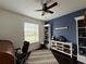 Bedroom has a blue accent wall, decor, and an area rug on the dark wood floor at 541 Kistler Cir, Clermont, FL 34715