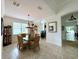 Dining room featuring a glass table, wicker chairs, tiled flooring, and natural light from a nearby window at 541 Kistler Cir, Clermont, FL 34715