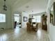 Cozy dining room with wicker furniture, tile floors, and natural light from a window at 541 Kistler Cir, Clermont, FL 34715