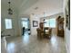 Bright dining room features a glass-top table with wicker chairs, natural light, and tiled floors at 541 Kistler Cir, Clermont, FL 34715