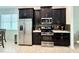 Well-equipped kitchen features stainless steel appliances, dark cabinetry, and a tiled backsplash at 541 Kistler Cir, Clermont, FL 34715