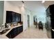 Open-concept kitchen with dark cabinets, stainless steel appliances, and tile flooring that flows into the adjacent dining area at 541 Kistler Cir, Clermont, FL 34715