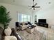 Inviting living room with a comfortable sofa, plush rug, and ample natural light from large windows at 541 Kistler Cir, Clermont, FL 34715