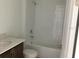 Standard bathroom with a shower-over-bath setup and a single sink vanity at 5733 Haystack Drive, St Cloud, FL 34771