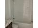 A bright bathroom featuring sleek countertops, a full tub, and modern hardware at 5733 Haystack Drive, St Cloud, FL 34771