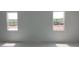 Bright bedroom with two windows overlooking the expansive green property at 5733 Haystack Drive, St Cloud, FL 34771