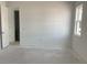 An unfinished bedroom with a view from the window, a door, and an unfinished floor at 5733 Haystack Drive, St Cloud, FL 34771
