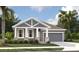 Charming single-story home featuring stone accents, gray siding and a well manicured lawn at 5733 Haystack Drive, St Cloud, FL 34771