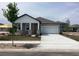 Traditional home with covered porch, stone pillar accents, attached garage and concrete driveway at 5733 Haystack Drive, St Cloud, FL 34771