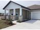 Inviting front porch with stone pillar accents and white columns, adding architectural interest at 5733 Haystack Drive, St Cloud, FL 34771