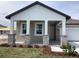 Inviting front porch with stone pillar accents and white columns, exuding curb appeal at 5733 Haystack Drive, St Cloud, FL 34771