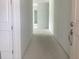 Bright hallway with white walls showcasing the layout and new construction at 5733 Haystack Drive, St Cloud, FL 34771