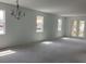 Spacious living room area with new construction, ample windows, and a chandelier at 5733 Haystack Drive, St Cloud, FL 34771