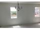 Spacious living room area with new construction, ample windows, and a chandelier at 5733 Haystack Drive, St Cloud, FL 34771