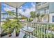 Relaxing balcony featuring a table, potted plants and pleasant neighborhood views at 611 Campus St # 160, Celebration, FL 34747