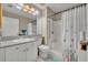 Bright bathroom featuring a walk-in shower with curtain and accessible sink at 611 Campus St # 160, Celebration, FL 34747