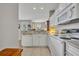 Well-lit kitchen boasts white appliances, countertops, and cabinetry with an adjoining dining area at 611 Campus St # 160, Celebration, FL 34747