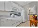 Bright kitchen featuring white cabinets, appliances, and a convenient pantry for ample storage at 611 Campus St # 160, Celebration, FL 34747