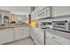 Well-lit kitchen boasts white appliances, countertops, and cabinetry with an adjoining dining area at 611 Campus St # 160, Celebration, FL 34747