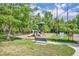 Lovely community playground featuring colorful equipment and mature trees at 611 Campus St # 160, Celebration, FL 34747