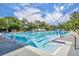 Gorgeous community pool with clear blue water, seating and lush landscaping at 611 Campus St # 160, Celebration, FL 34747
