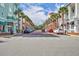 Charming street view, lined with colorful buildings, flags and palm trees at 611 Campus St # 160, Celebration, FL 34747