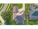 An aerial view showcasing the detailed roof design, manicured lawn, and screened-in pool of this luxury home at 6121 Oxbow Bend Ln, Port Orange, FL 32128