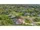 This aerial shot shows the beautiful neighborhood, mature trees, and the home's landscaping, and screened-in pool at 6121 Oxbow Bend Ln, Port Orange, FL 32128