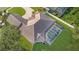 Aerial view of a meticulously maintained home featuring a screened-in pool, and a tile roof at 6121 Oxbow Bend Ln, Port Orange, FL 32128