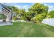 Lush green lawn borders a white fence and the screened lanai, creating a private backyard oasis at 6121 Oxbow Bend Ln, Port Orange, FL 32128