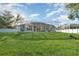Expansive screened lanai and lush green backyard offer a private outdoor retreat at 6121 Oxbow Bend Ln, Port Orange, FL 32128