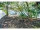 The tranquil backyard setting features a white fence bordering the manicured lawn and partial view of a screened lanai at 6121 Oxbow Bend Ln, Port Orange, FL 32128