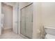 This bathroom includes a glass shower, toilet, and access to other rooms at 6121 Oxbow Bend Ln, Port Orange, FL 32128