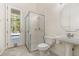 Bathroom with stand-up shower and pedestal sink, featuring a glass door leading to the pool at 6121 Oxbow Bend Ln, Port Orange, FL 32128