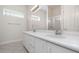 Bright bathroom features a double vanity, glass block window, and a shower with sliding glass door at 6121 Oxbow Bend Ln, Port Orange, FL 32128