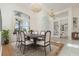 Bright dining room with elegant chandeliers, large windows, and space for a large gathering at 6121 Oxbow Bend Ln, Port Orange, FL 32128