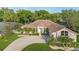 Beautiful home featuring lush landscaping, a winding driveway, and a welcoming facade at 6121 Oxbow Bend Ln, Port Orange, FL 32128