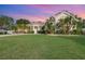 Charming home features a lush lawn, tropical landscaping, and a welcoming entrance at 6121 Oxbow Bend Ln, Port Orange, FL 32128