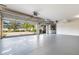 Spacious garage with epoxy flooring and an open door showing the home's exterior and manicured landscaping at 6121 Oxbow Bend Ln, Port Orange, FL 32128