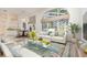 Bright and airy living room with large arched windows, comfortable seating, and elegant decor at 6121 Oxbow Bend Ln, Port Orange, FL 32128